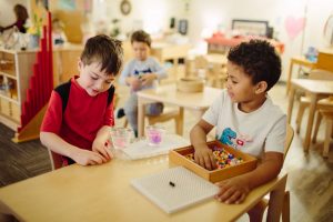 Kindergartners learning independently in the classroom.